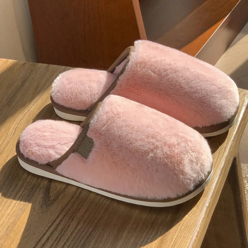 Solid colour PVC plush slippers with non-slip sole and car stitching detail on a wooden floor.