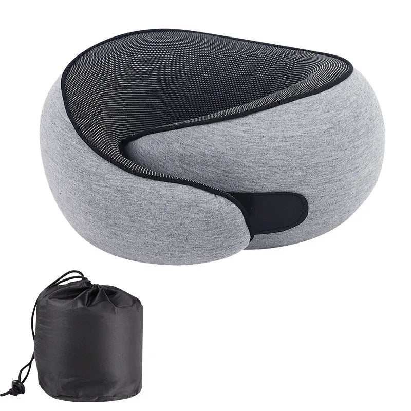 U-shaped grey memory foam travel neck pillow with a black storage bag on a plain background.
