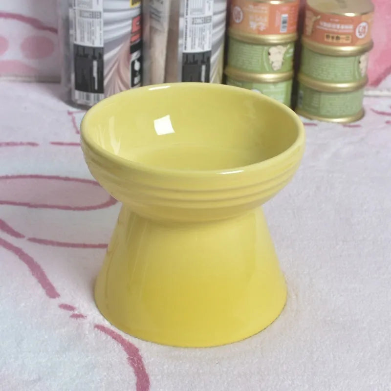 Black ceramic pet bowl with a raised foot and high neck guard for dogs and cats.