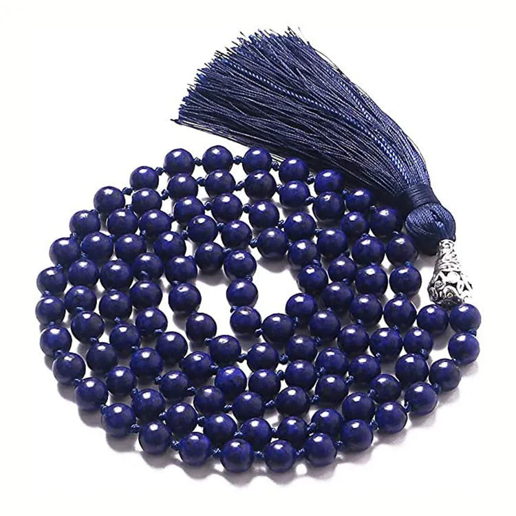 Long agate tassel necklace with geometric stone beads in various colours on a neutral background.