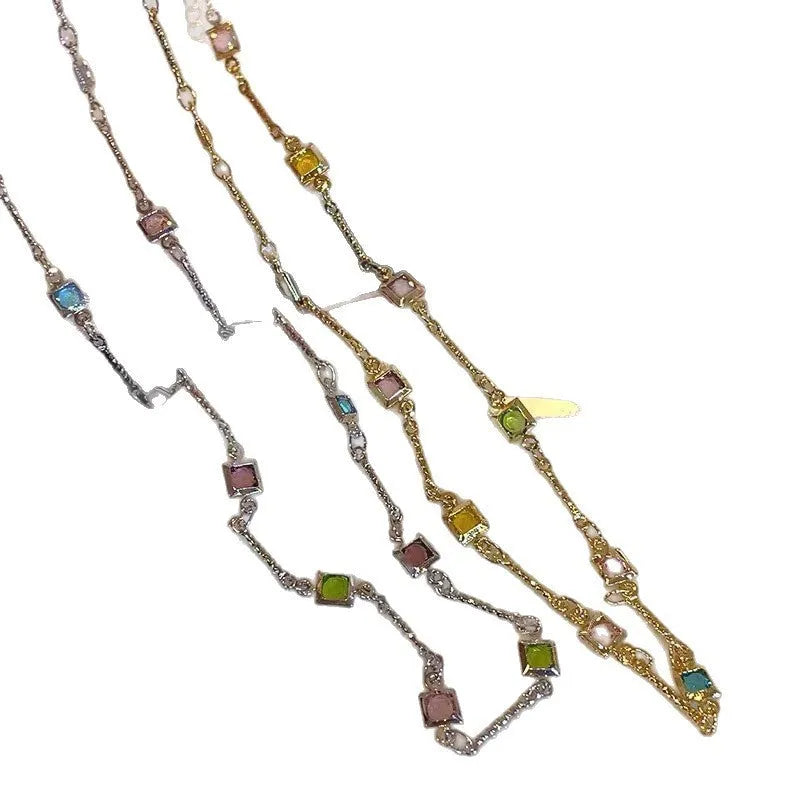 Fine gold-tone geometric necklace with a square clear crystal pendant on a clavicle-length chain.
