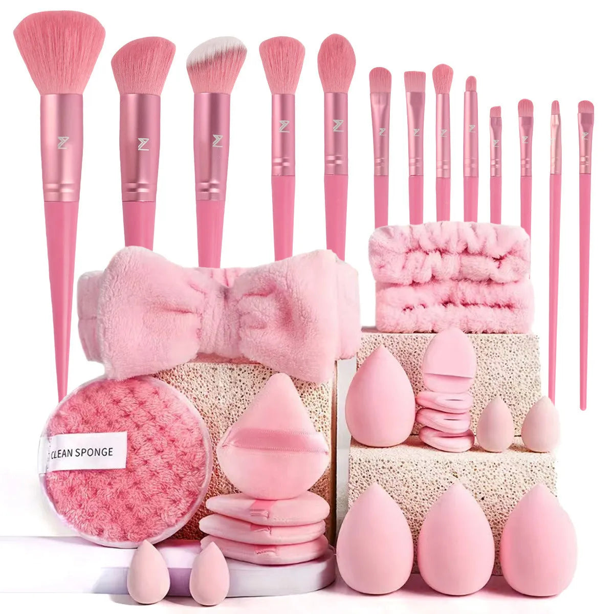 Beauty tool combination set with multiple pieces in pink, brown and purple colours for face wash and makeup application