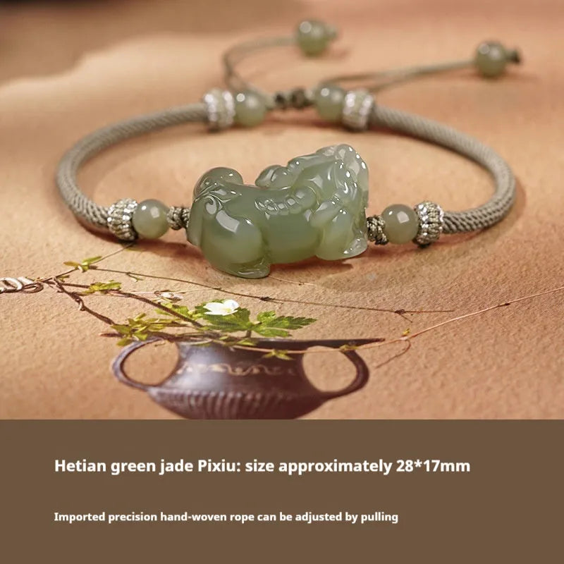 A Hetian jade bracelet with braided black and red rope in a Chinese style design.