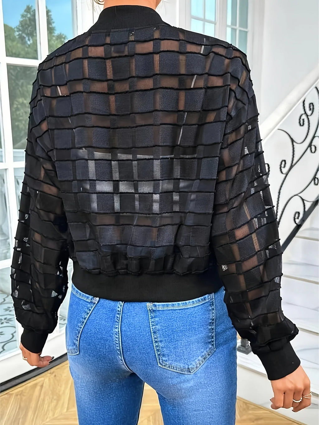 Black women's semi-transparent jacket with geometric pattern, zip-up front, and long sleeves
