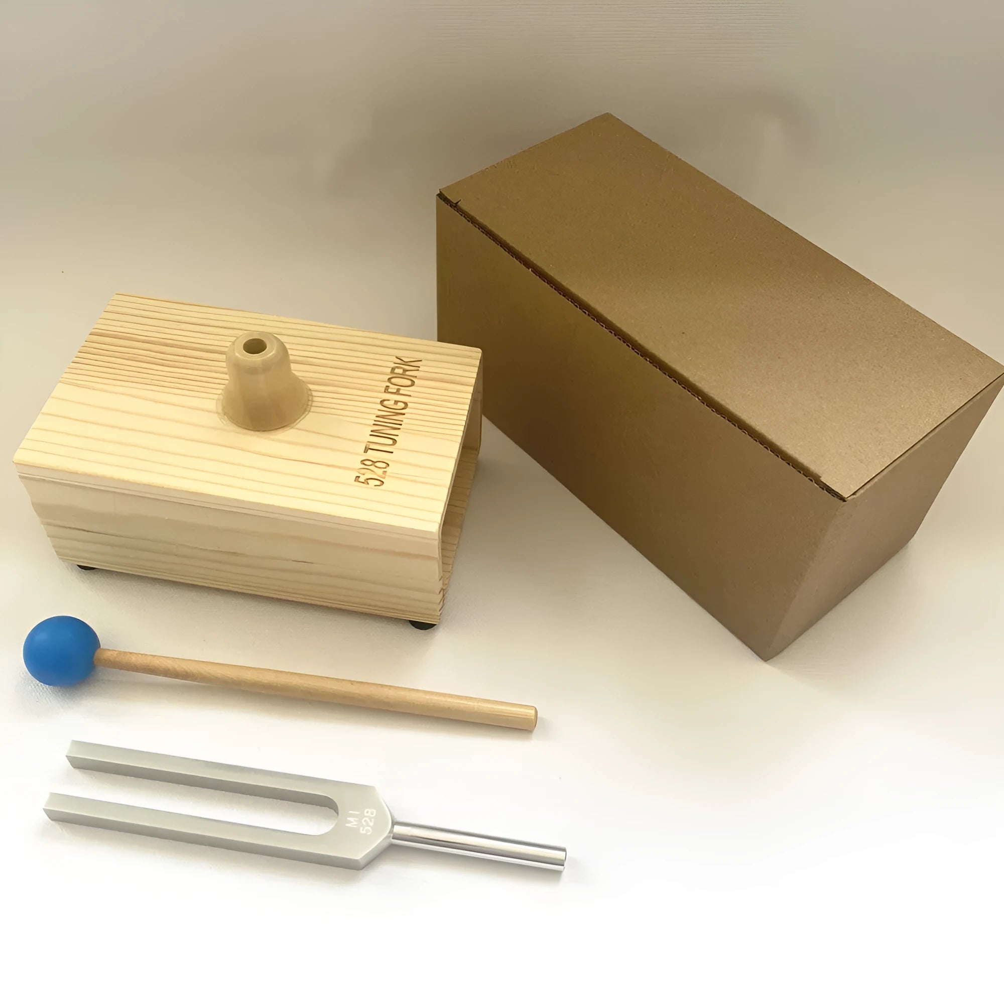 Aluminium alloy 432Hz tuning fork with integrated speaker in kraft paper packaging