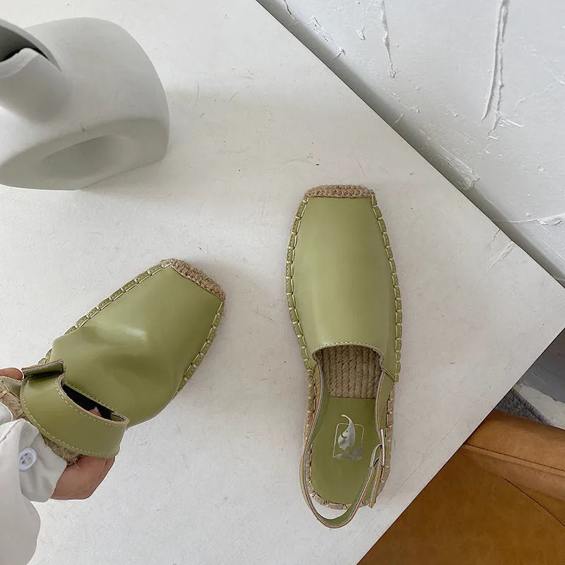 Women's beige retro fisherman flat sandals with canvas upper and animal pattern detail.