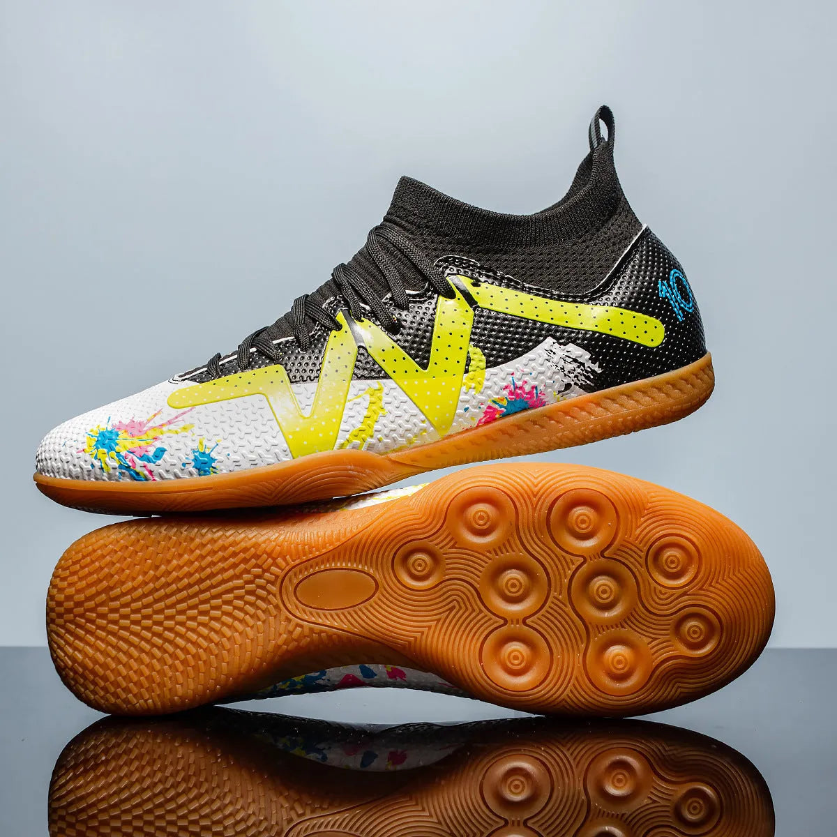Low-top soccer shoes with broken spike nails on non-slip rubber outsole in black and yellow colourway