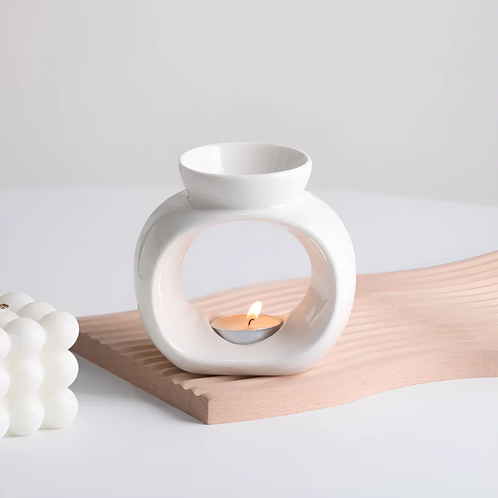 White Nordic style ceramic aromatherapy stove ornament on a table.