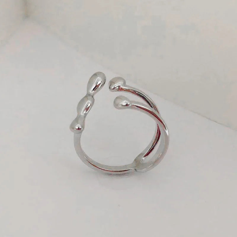Women's brass opening ring with gold finish and circle sphere design