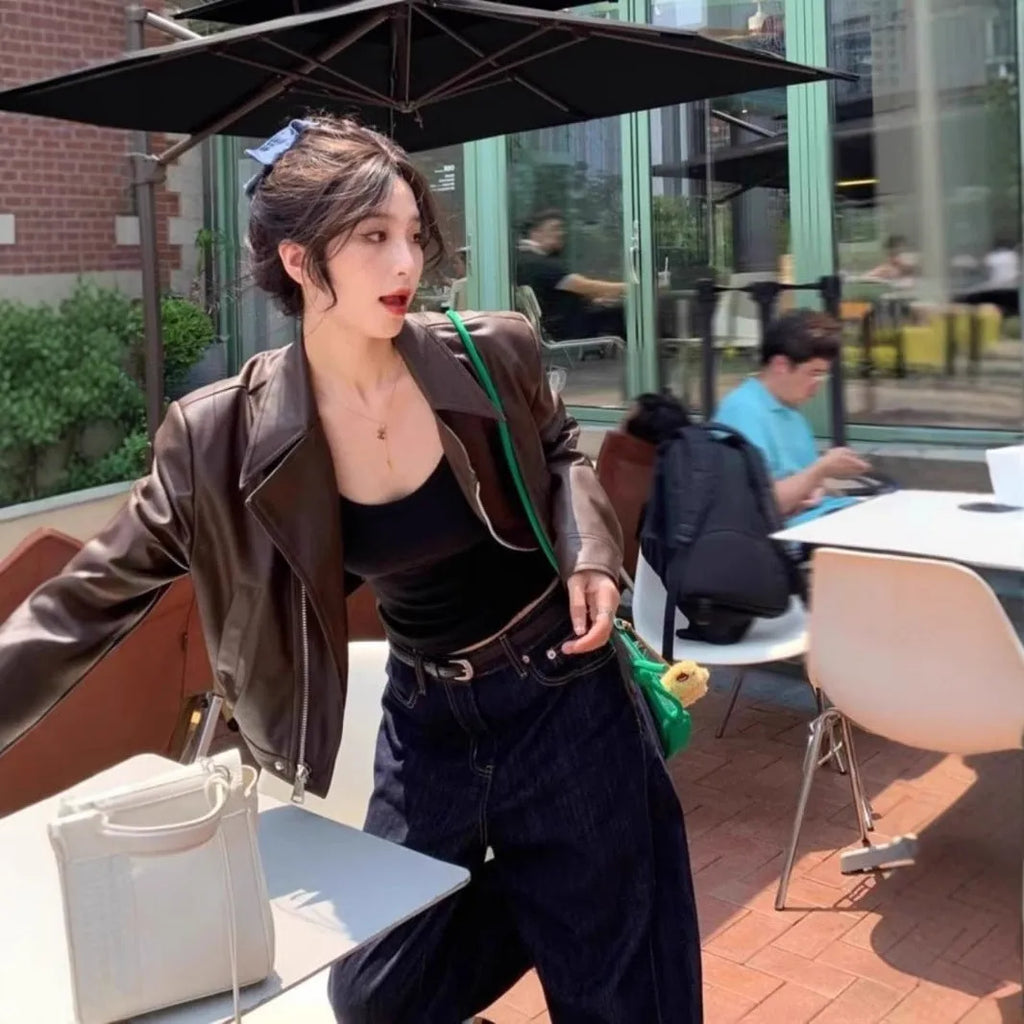 Women's brown retro imitation leather jacket with long sleeves, pockets, and a slim fit.