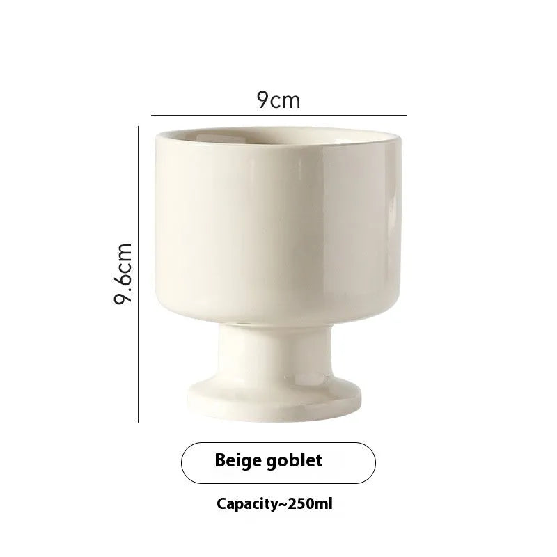 Hand-pinched irregular shaped ceramic mug in a solid colour, shown from the side.