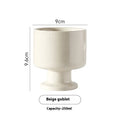 Hand-pinched irregular shaped ceramic mug in a solid colour, shown from the side.