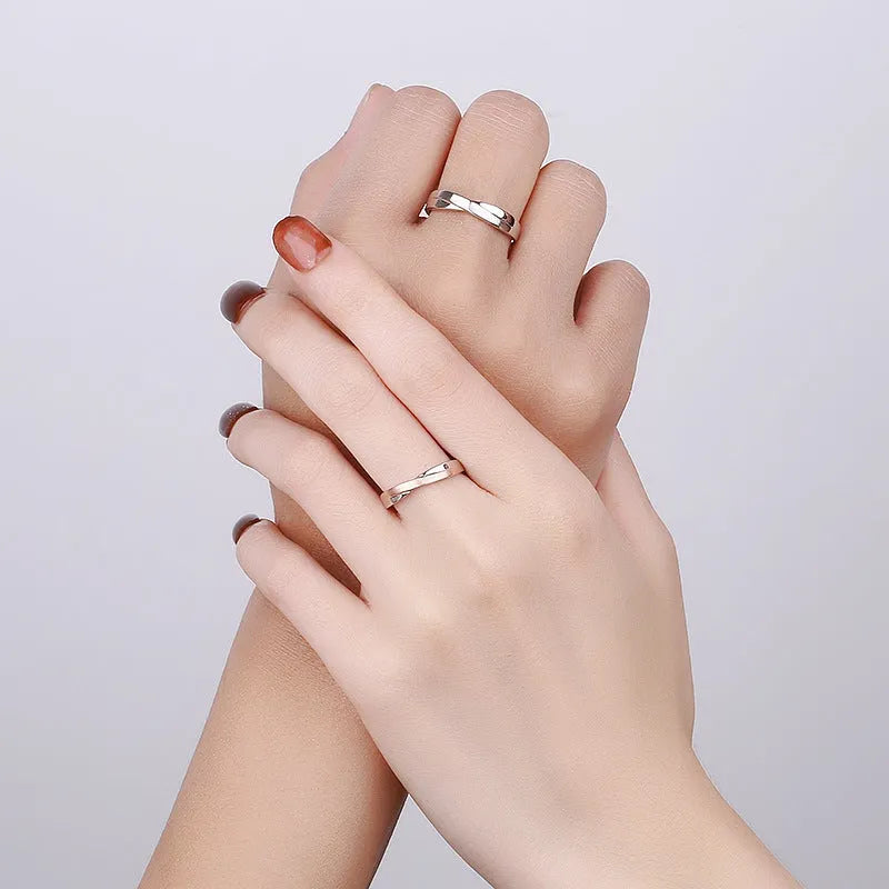 S925 sterling silver Mobius strip interwoven double knot adjustable couple ring on finger showing geometric infinity design