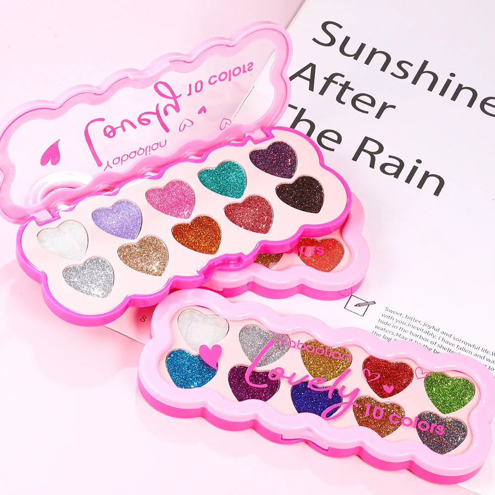 Pearlescent heart-shaped ten-colour sequin eyeshadow palette open, showing pink, blue, black, and coral shades.
