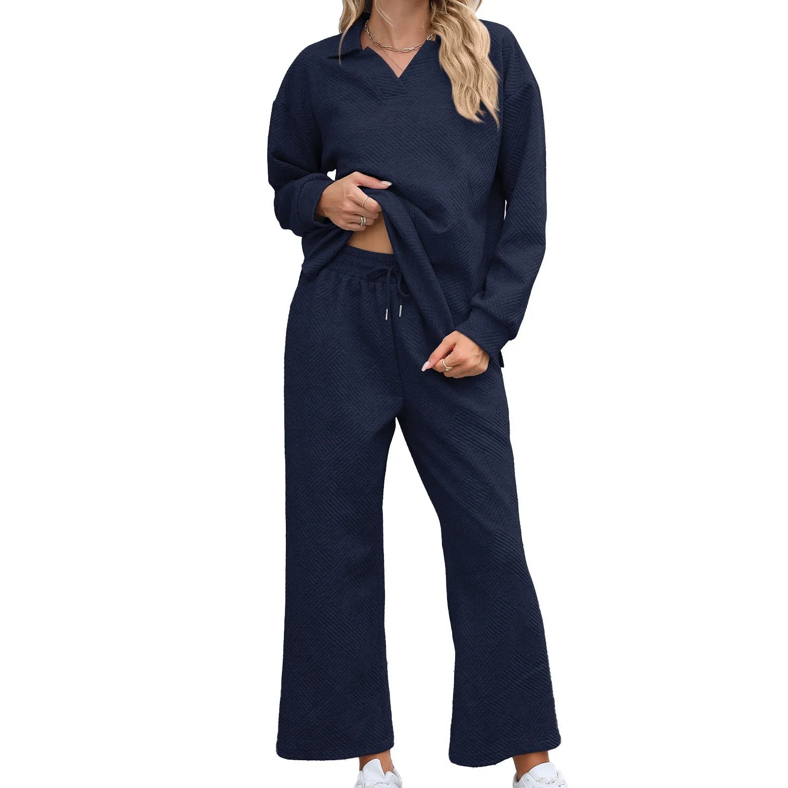 Women's geometric patterned knitted suit set with lapel sweater and cropped trousers in multiple colours.