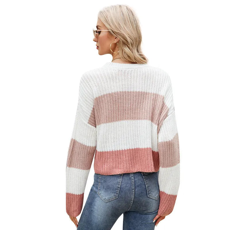 Women's short striped loose-fitting acrylic pullover sweater on a hanger.