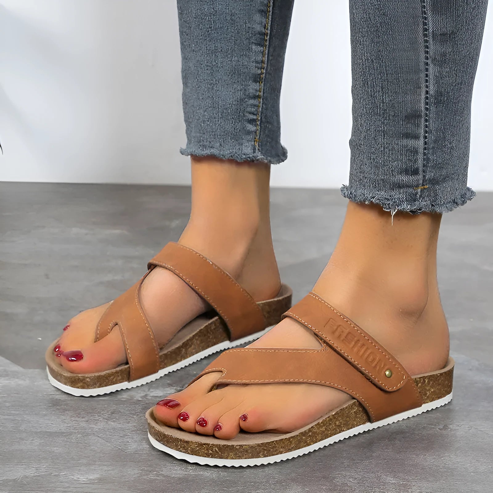 Flat toe ring thick-soled flip-flops in a solid colour on a light background