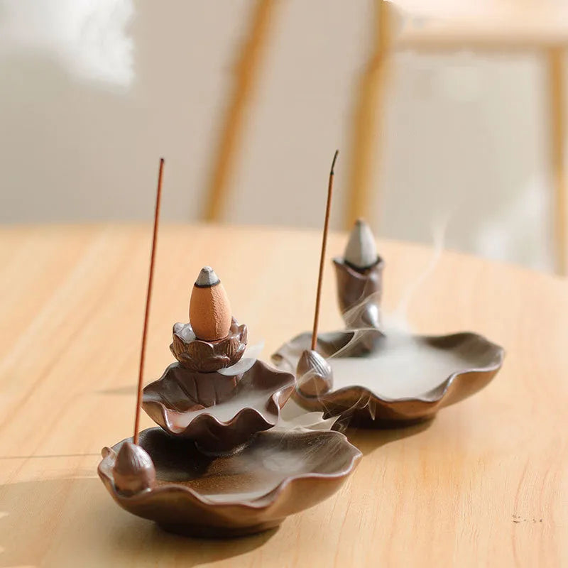 Square purple clay ceramic reverse flow incense burner with lotus and plum blossom decoration.
