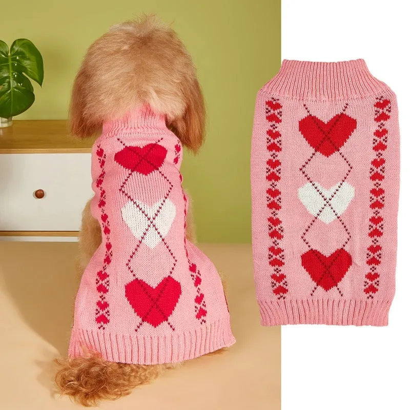 Dog wearing acrylic jumper with love heart and bow designs in red and pink colour patterns