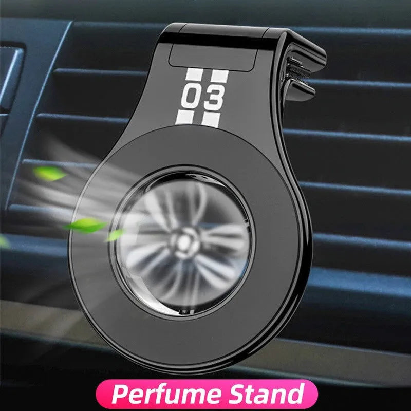 Magnetic car air vent phone holder with perfume dispenser in black, showing phone attached and fragrance slot.