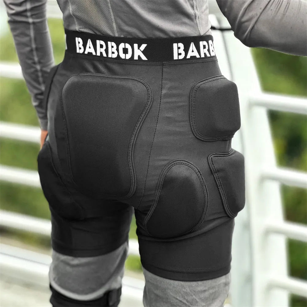 Black protective spandex trousers with integrated hip pads for skating and skateboard fall protection.