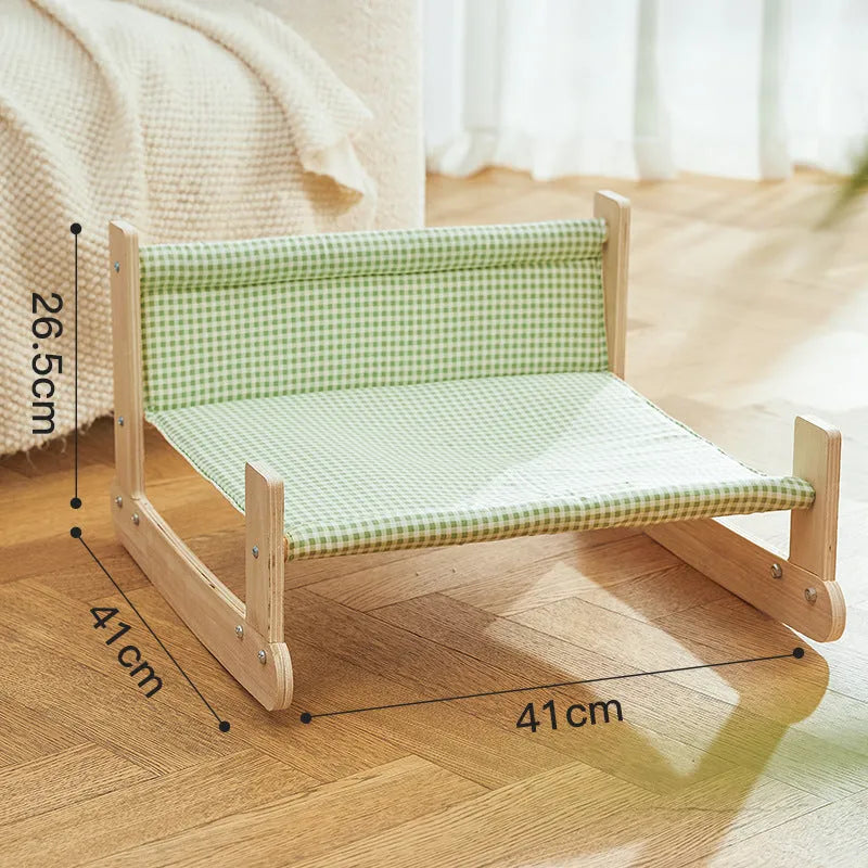 Green wooden elevated cat hammock bed for indoor lounging