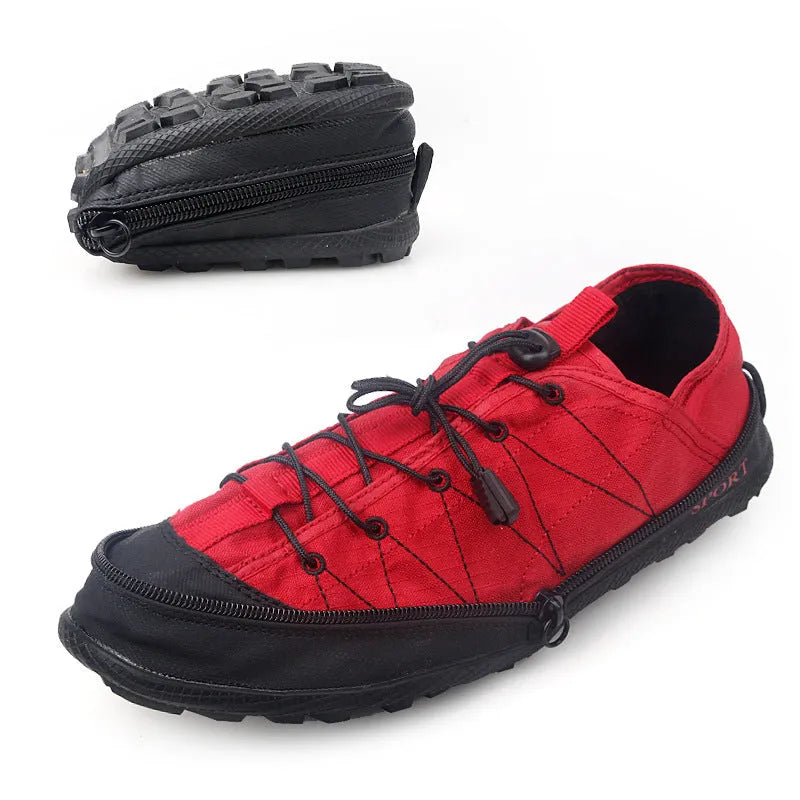 Orange portable folding outdoor hiking shoe with side zipper on a grey background.