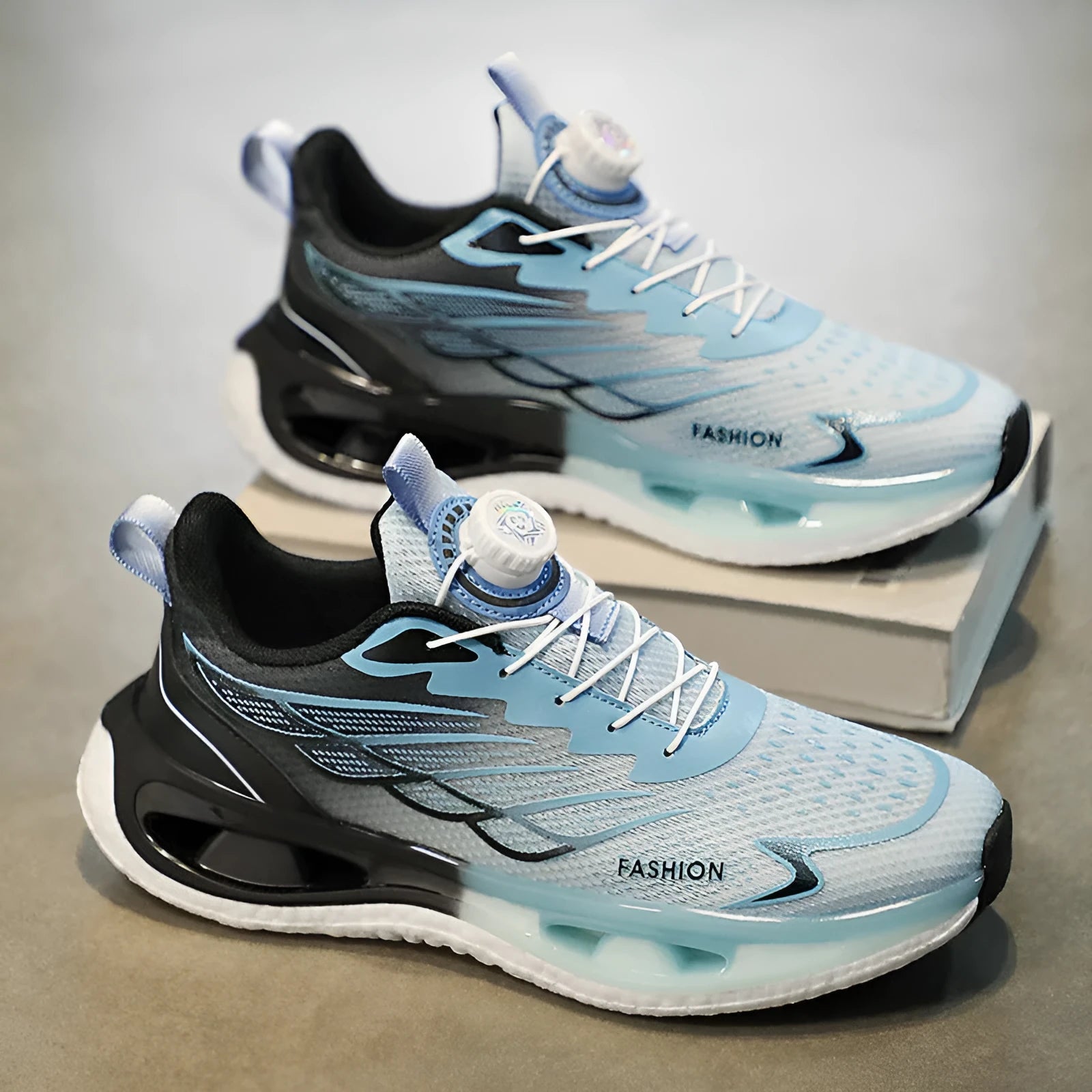 Youth men's low-top rotating button sneaker in light blue mesh with a rubber sole.