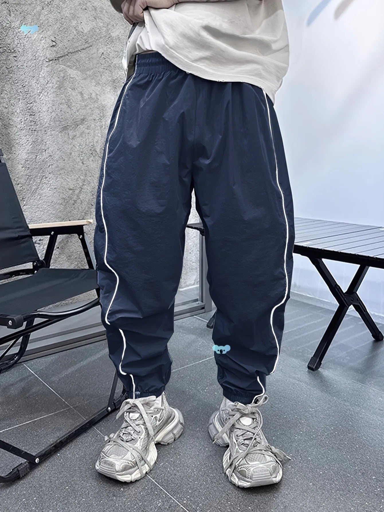 Men's blue bamboo fibre cropped sports trousers with a loose casual fit on a hanger.