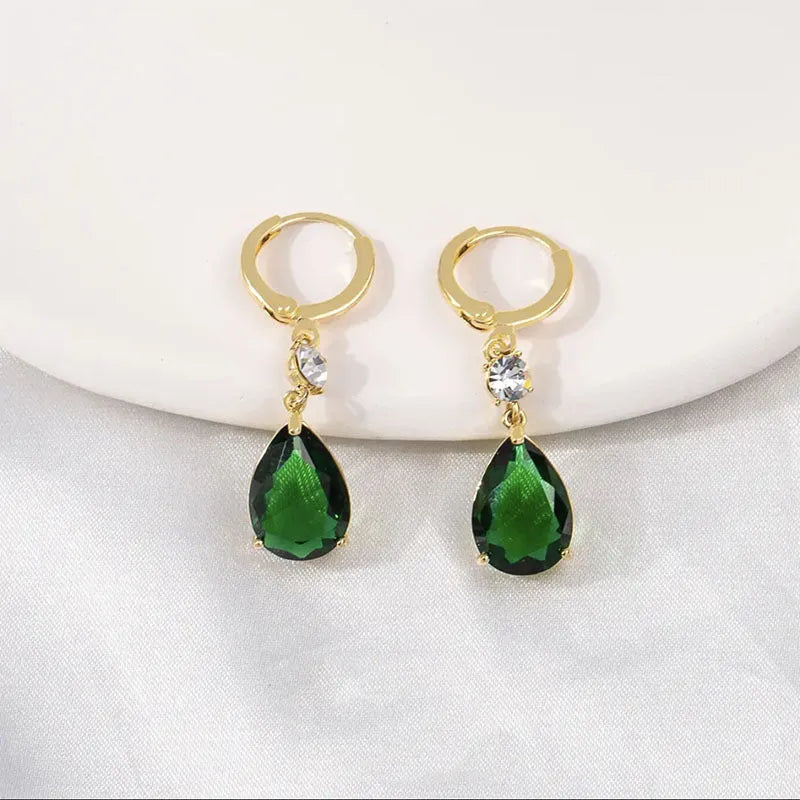 Green geometric teardrop earrings with alloy construction showing structured patterning