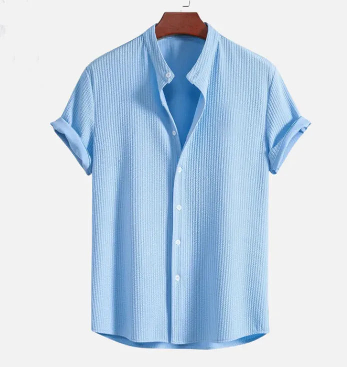 Men's loose fit short sleeve polyester summer shirt on a hanger, shown in a light blue colour.