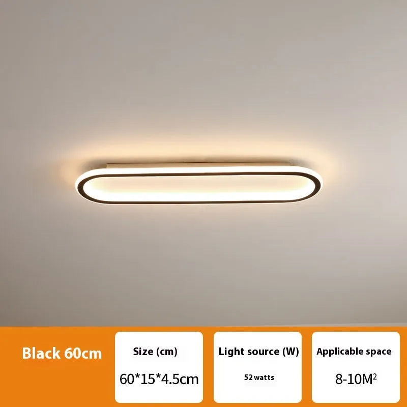 Minimalist black strip ceiling lamp with aluminium body and PVC shade mounted on a white ceiling.