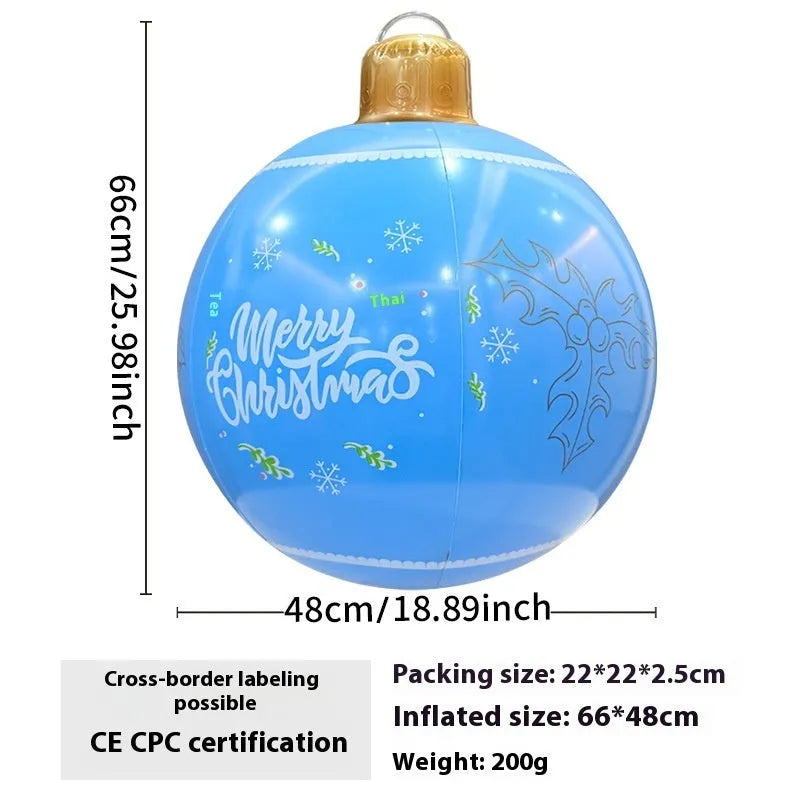 Large red inflatable Christmas ball with snowflake pattern and flash light, shown with a hand pump in a garden setting.