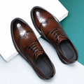 Men's black and brown brogue leather shoes in business style with traditional detailing
