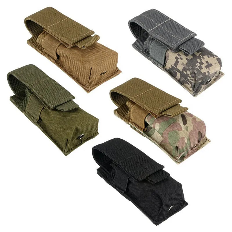 Black tactical Molle waist bag with elastic cord closure, shown next to a pistol cartridge for scale.