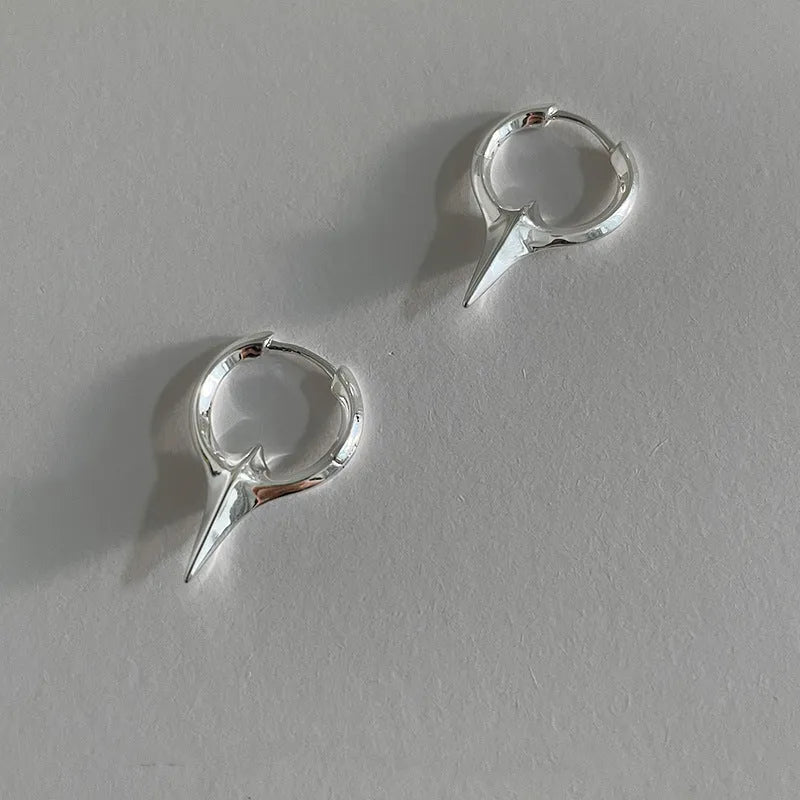 Women's geometric star-shaped ear clip with an electroplated platinum or white gold finish.