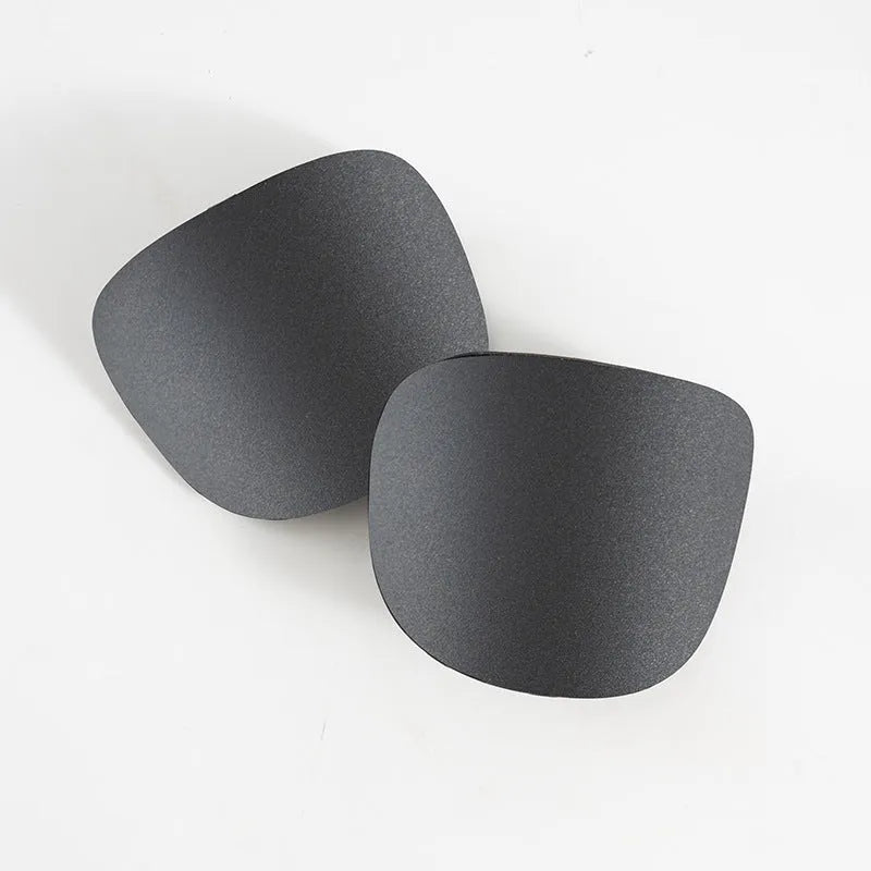 Pair of black PU mini shin guards for sports protection, showing S size.