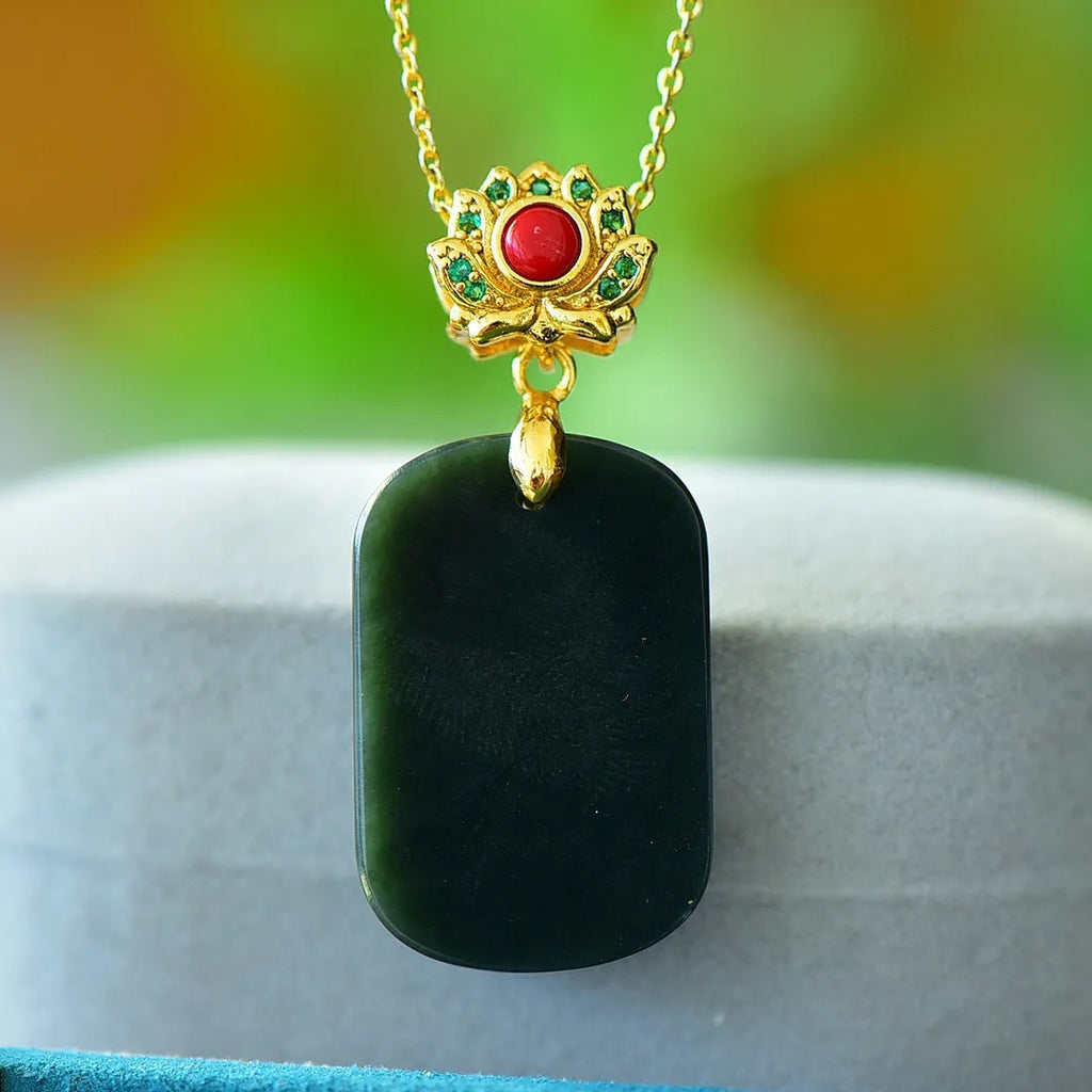 Flat gray and ink blue Hetian Jade pendant with copper inlaid decoration on a necklace.