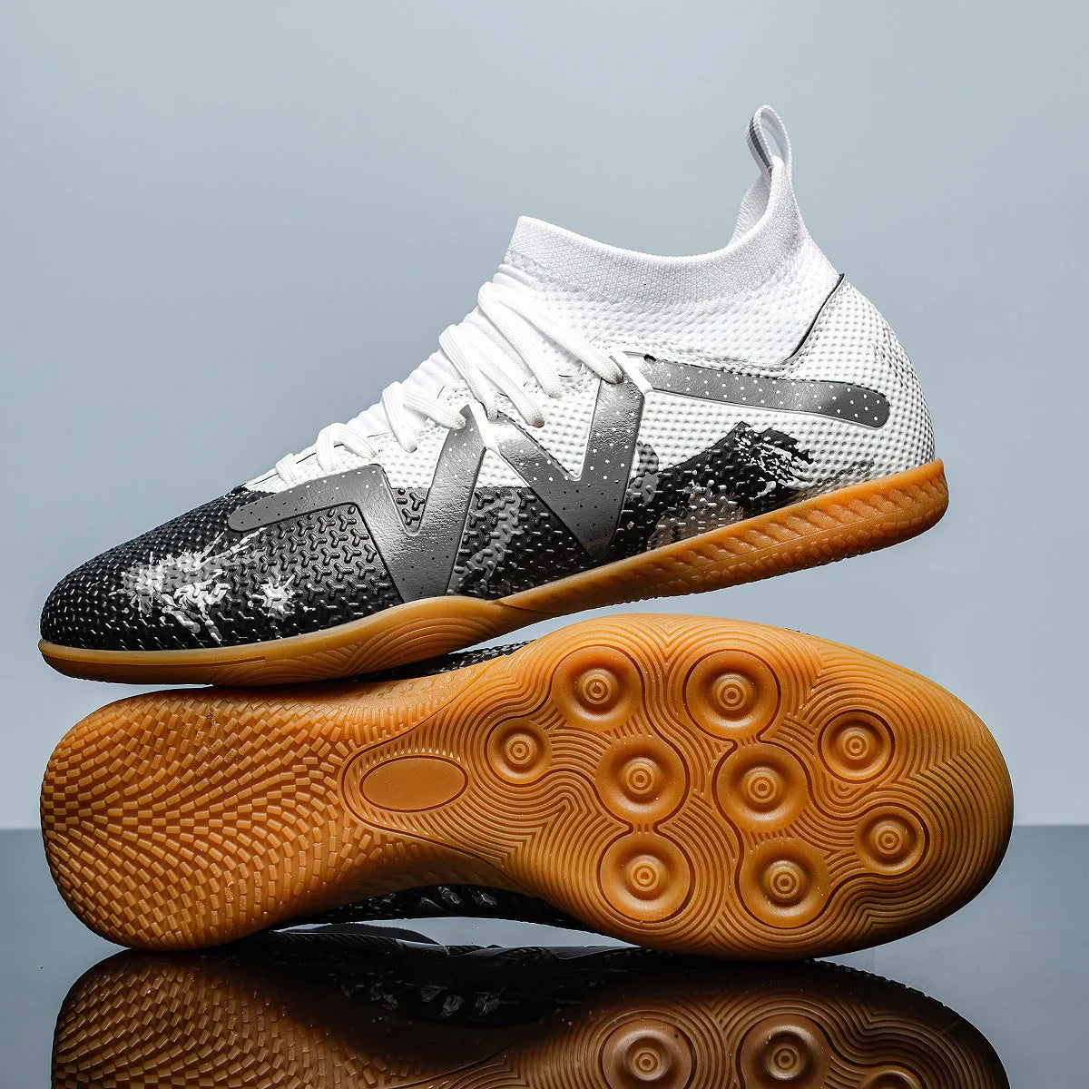 Low-top soccer shoes with broken spike nails on non-slip rubber outsole in black and yellow colourway