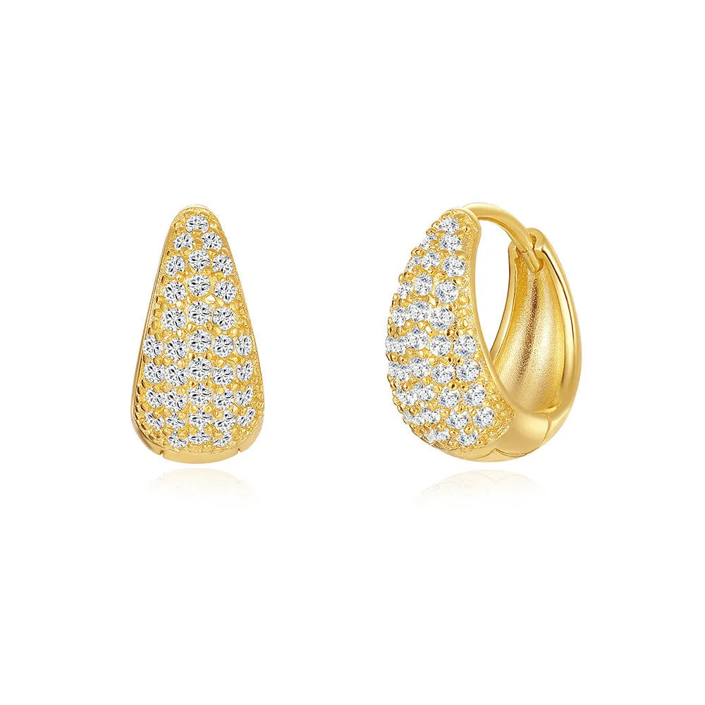 A pair of simple geometric brass earclip earrings with a round element and electroplated golden finish.