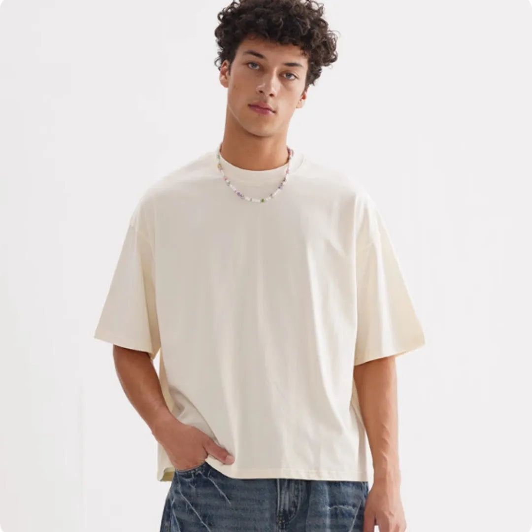 Man wearing a loose fit apricot coloured pure cotton t-shirt, short sleeves, casual American style.