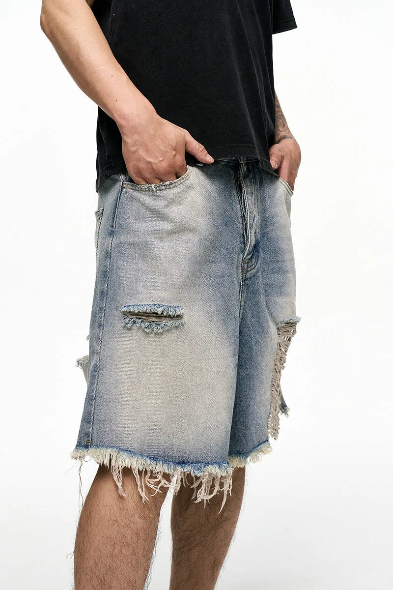 Light blue men's baggy denim shorts with a wide leg and mid waist on a plain background.