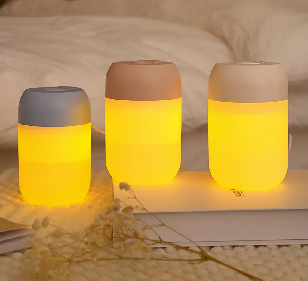 White cylindrical USB-powered mini humidifier with aromatherapy function on wooden desk