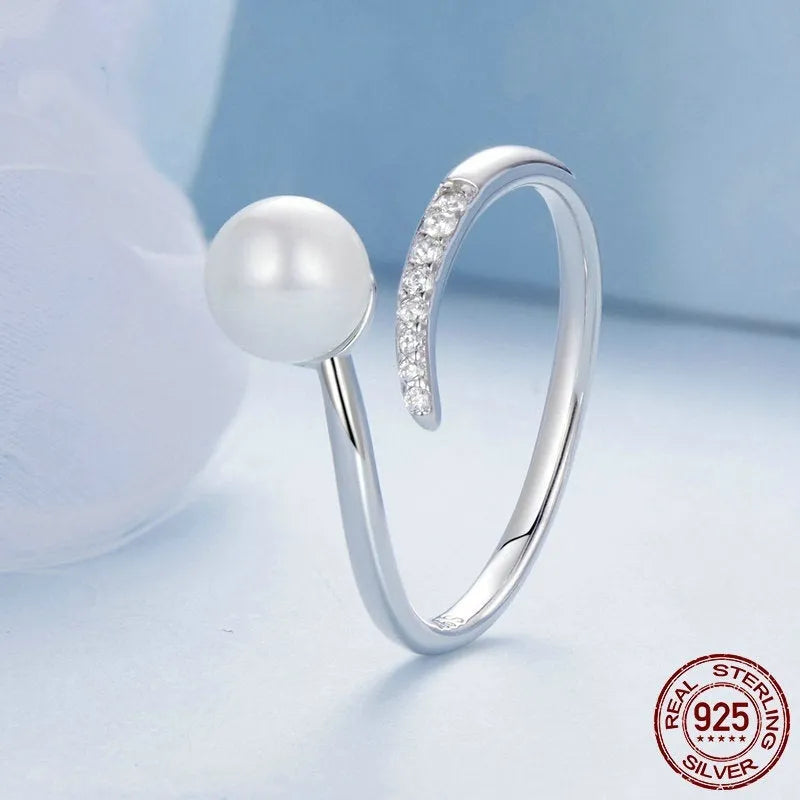 Sterling silver adjustable ring with freshwater pearl on open-loop design