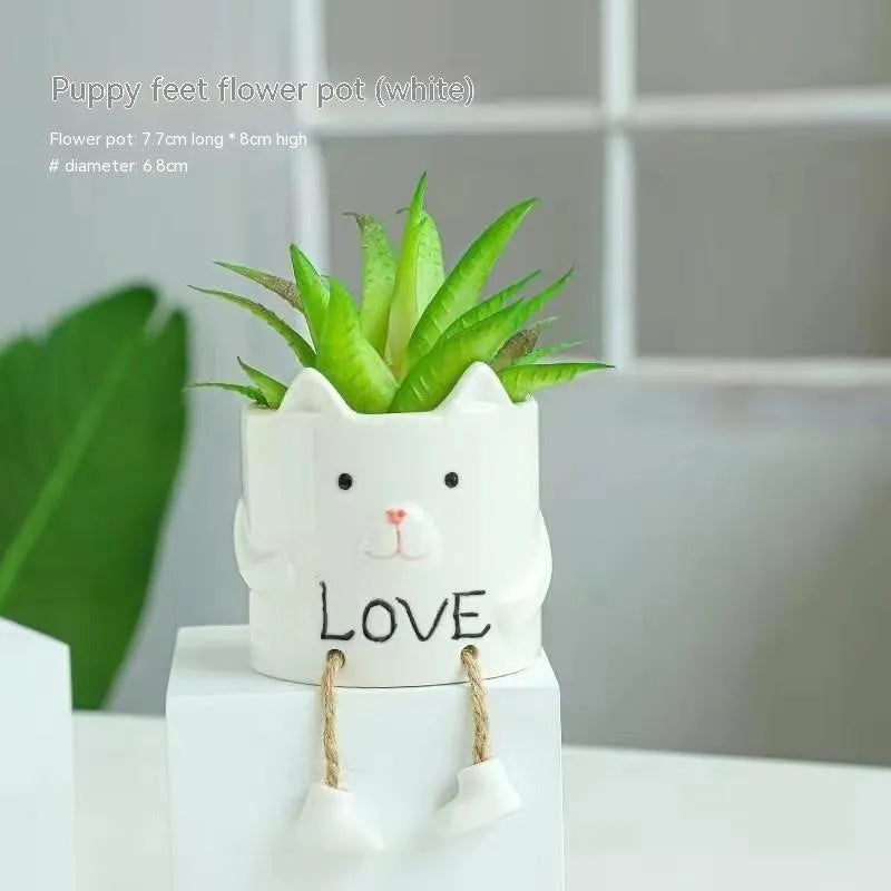 Cartoon style ceramic hanging foot flowerpot for succulent plants on a desktop.