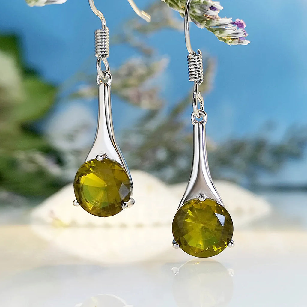 Olive green topaz coloured drop earrings with a water drop shape and minimalist retro design.