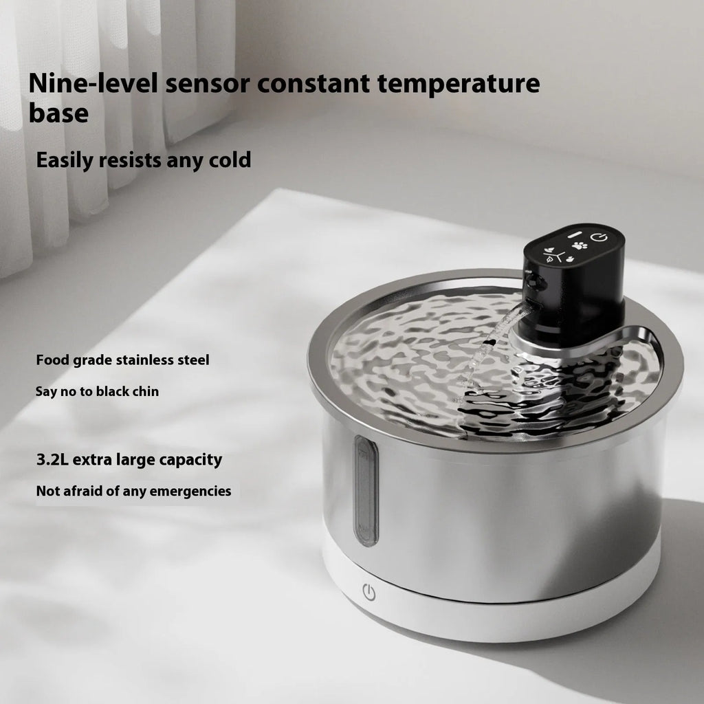 Black and white heated pet water fountain with stainless steel basin on a temperature control base.