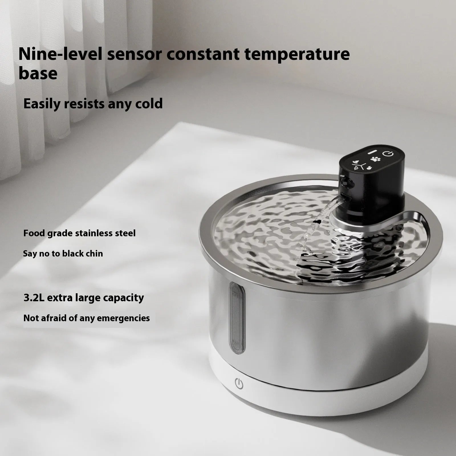 Black and white heated pet water fountain with stainless steel basin on a temperature control base.