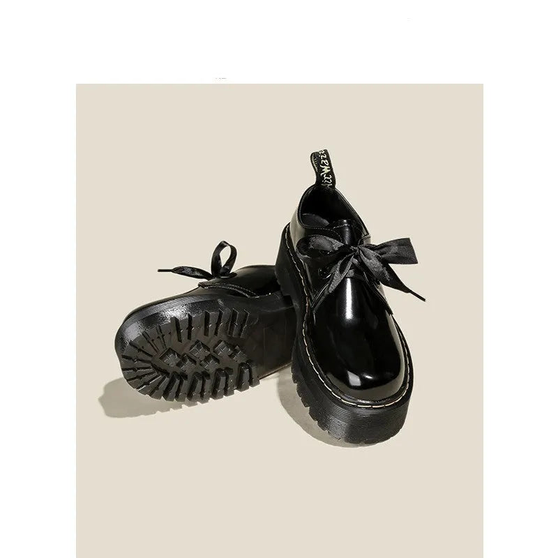 Women's black and white thick-soled leather shoes with lace-up closure and decorative straps