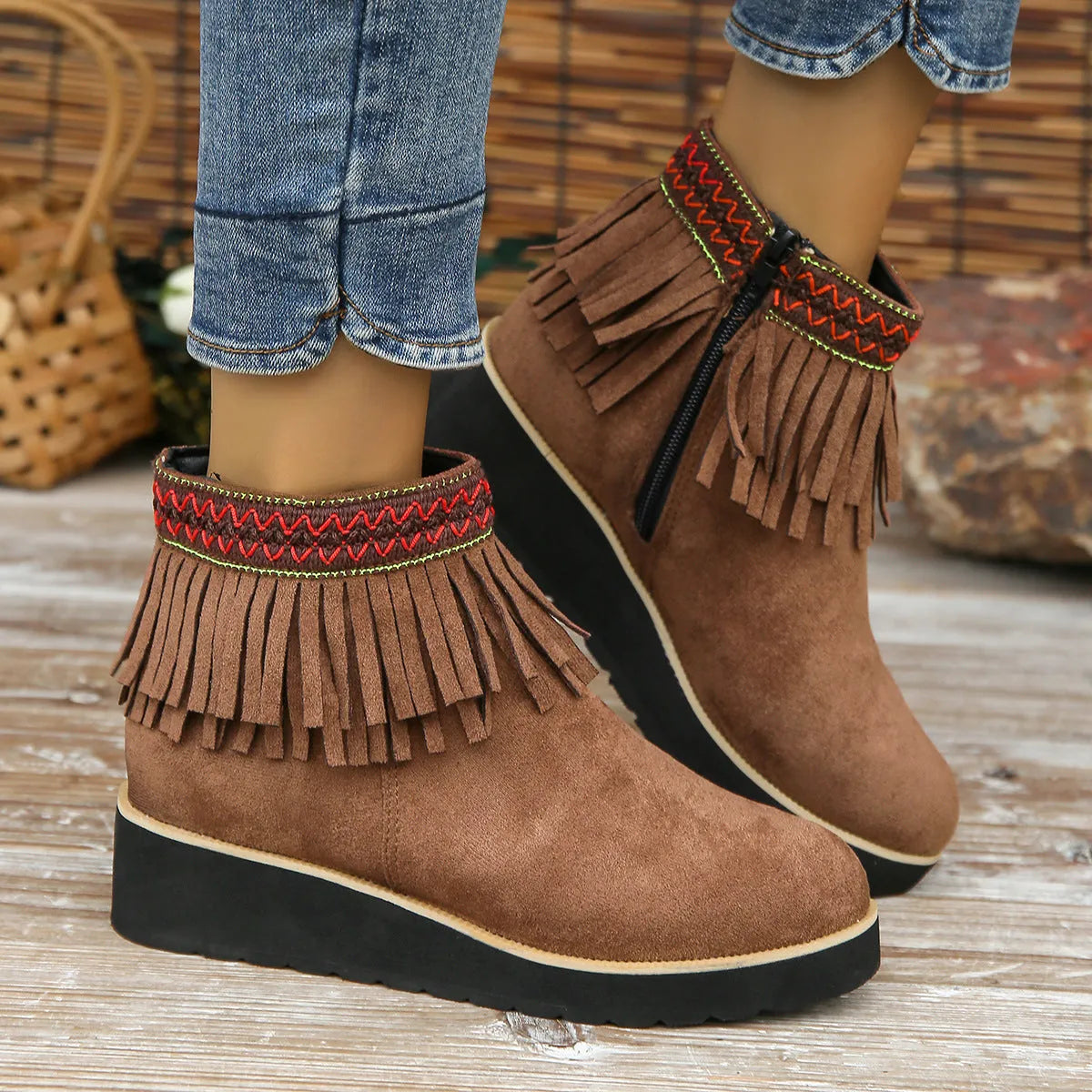 Women's black suede wedge ankle boots with side zip, tassel, and thick rubber sole.